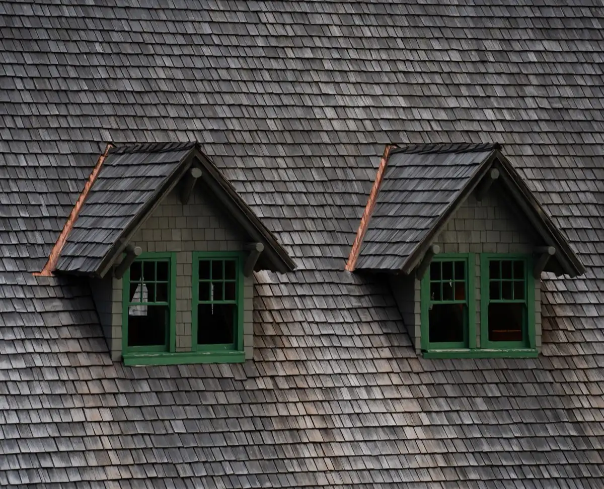 Dormers on a shingle roof in Gaithersburg, MD, where step flashing and kickout flashing carry water past the walls